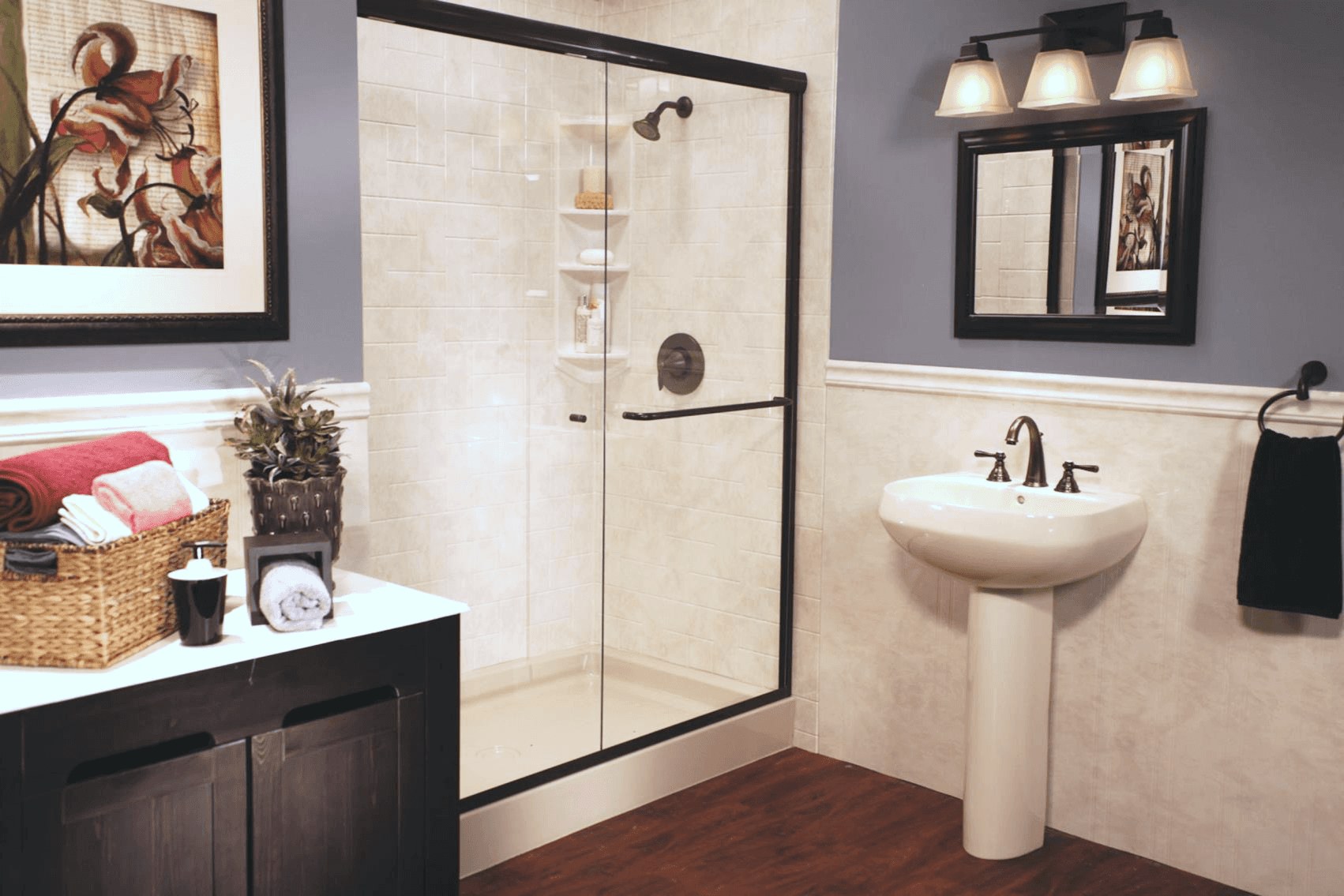 A walk-in shower with a low-threshold base, glass door and solid-surface wall surround, shown for illustration