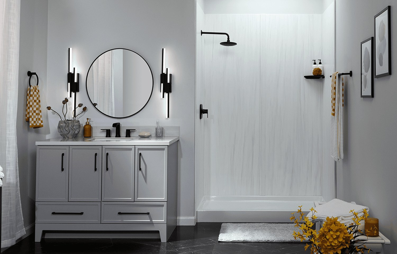 A modern shower with a white solid-surface wall surround and black fixtures beside a gray vanity, shown for illustration