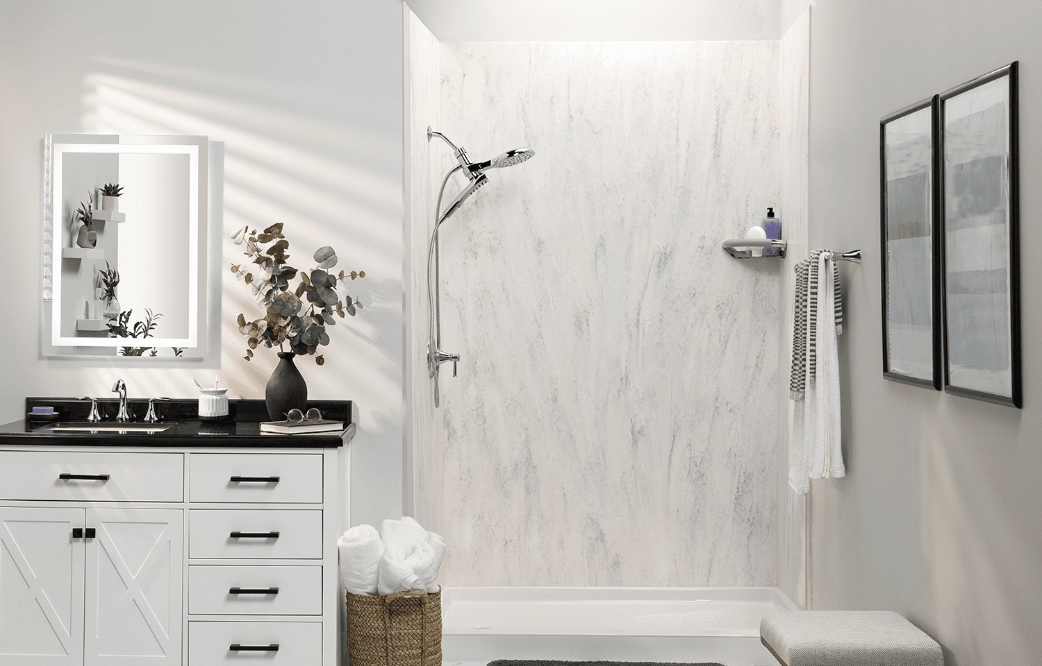A shower with a stone-look solid-surface wall surround, glass panel and brushed fixtures, shown for illustration